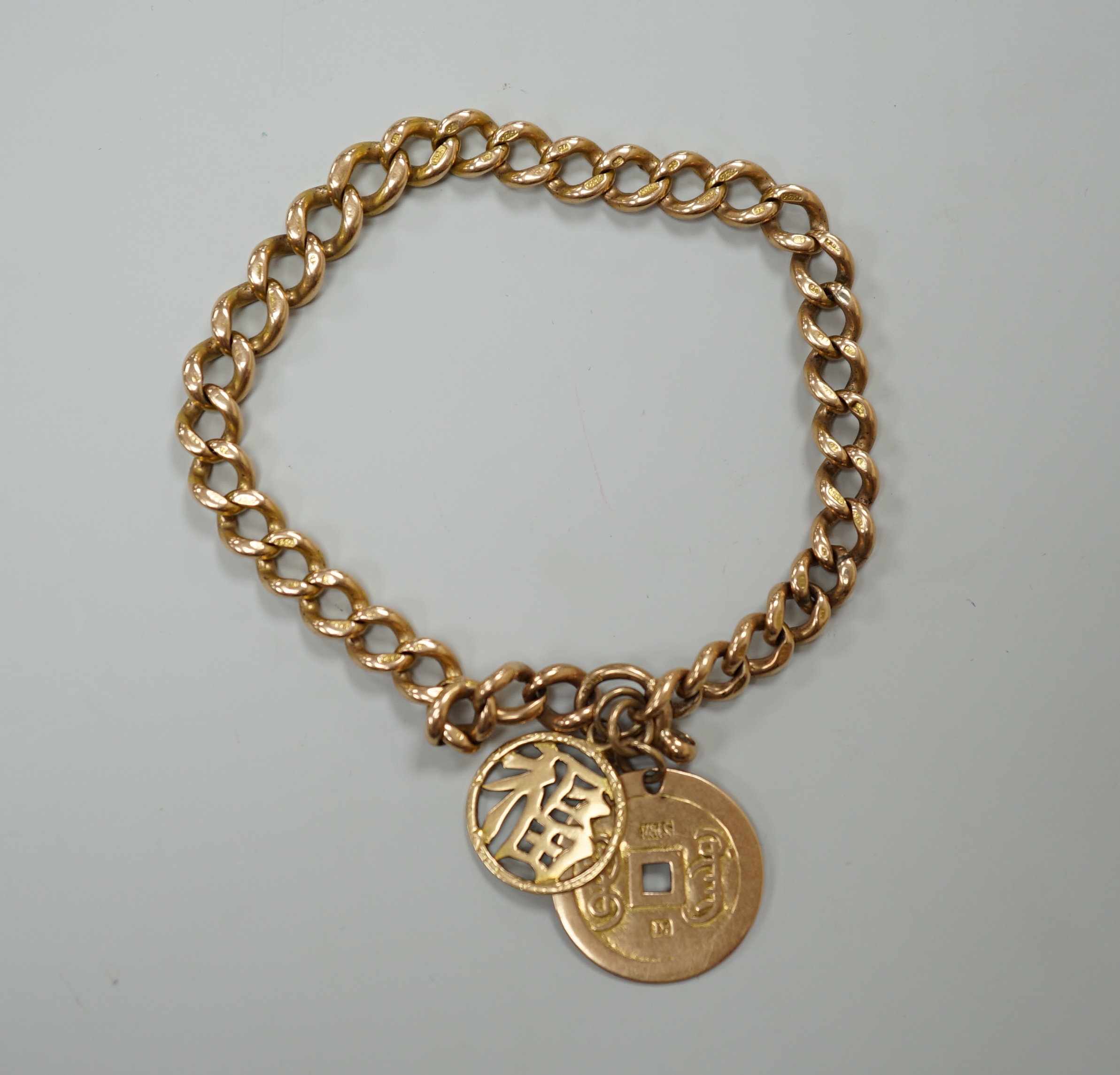 A 15ct gold link marked curblink bracelet, with pierced Chinese 18K coin charm, and an unmarked Chinese character charm, gross 36.7 grams